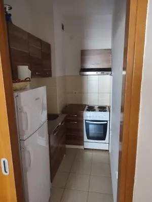 a kitchen with a white stove and a refrigerator at Studio Vanja in Budva