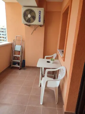 a room with a table and chairs and a fan at Studio Vanja in Budva