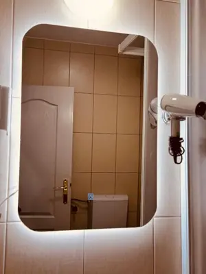 a reflection of a bathroom with a toilet in a mirror at Budva Felix Suites in Budva