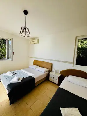 a bedroom with two beds and a chandelier at Budva Felix Suites in Budva