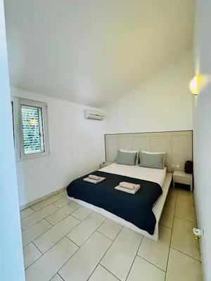 a bedroom with a bed with two towels on it at Budva Felix Suites in Budva
