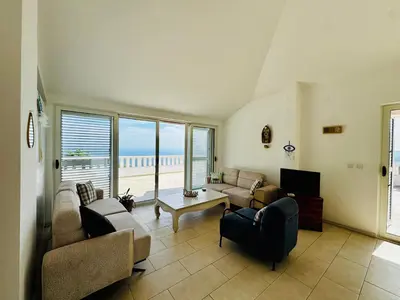 a living room with a view of the ocean at Budva Felix Suites in Budva