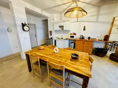 a kitchen and dining room with a wooden table at Budva Felix Suites in Budva