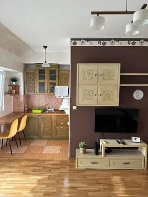 a kitchen with a table and a large television at Due Sorelle in Podgorica