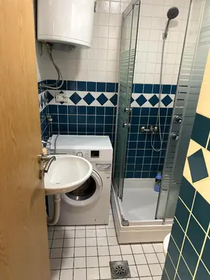 a bathroom with a sink and a washing machine at Due Sorelle in Podgorica