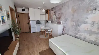 a small room with a bed and a kitchen at Kupidon in Dobra Voda