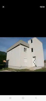 a large white building with two windows at Family house Grbalj in Kotor