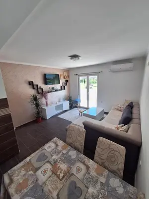 a living room with a couch and a table at Family house Grbalj in Kotor