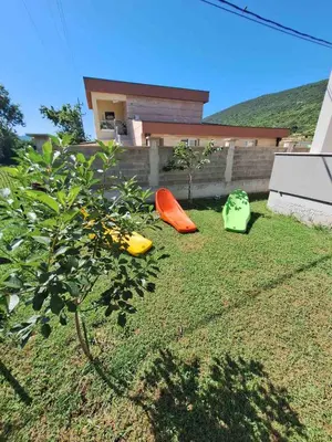 two kayaks sitting on the grass in front of a house at Family house Grbalj in Kotor
