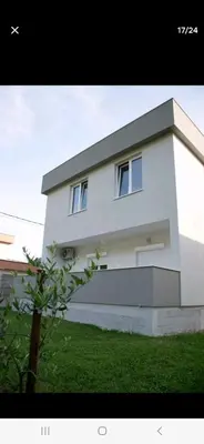 a white building with two windows on top of it at Family house Grbalj in Kotor