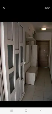 a small room with a bed and a door at Family house Grbalj in Kotor