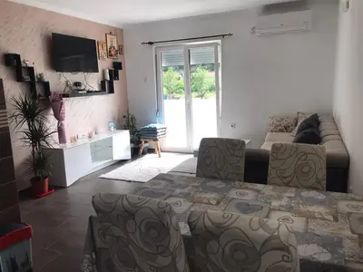 a living room with a couch and a table at Family house Grbalj in Kotor