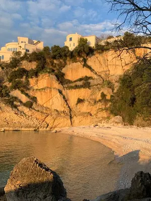 a group of buildings on top of a hill next to a body of water at Villa Lila in Utjeha
