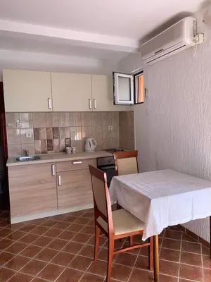 a kitchen with a table and two chairs and a table and a kitchen at Villa Lila in Utjeha