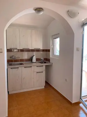 a kitchen with an archway in the middle of a room at Villa Lila in Utjeha