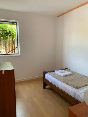 a white room with a bed and a window at Villa Lila in Utjeha