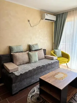 a living room with a gray couch and a yellow chair at Dale apartment Becici- Paradiso in Budva