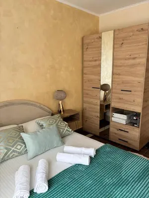a bedroom with a bed with towels on it at Dale apartment Becici- Paradiso in Budva