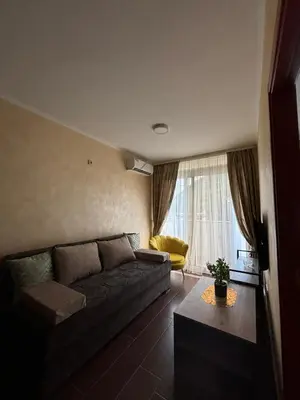 a living room with a couch and a yellow chair at Dale apartment Becici- Paradiso in Budva