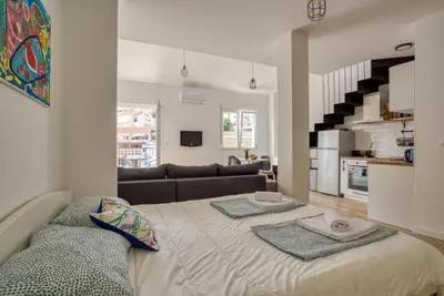 a living room with a large bed with two pillows on it at Magi-Family Rooftop Apartment Budva in Budva