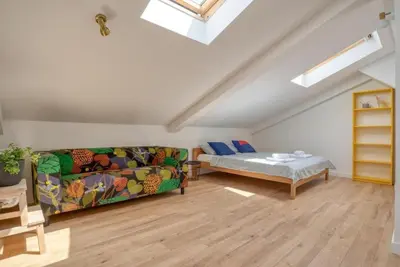 a living room with a couch and a bed at Magi-Family Rooftop Apartment Budva in Budva