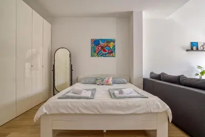 a bedroom with a bed and a couch at Magi-Family Rooftop Apartment Budva in Budva