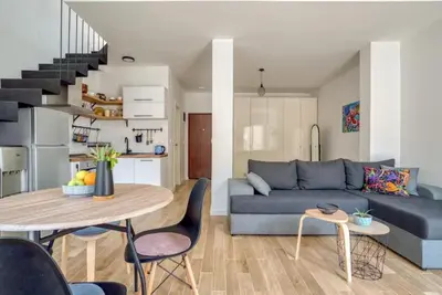 a living room with a blue couch and a table at Magi-Family Rooftop Apartment Budva in Budva