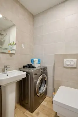 a bathroom with a washing machine and a sink at Magi-Family Rooftop Apartment Budva in Budva
