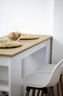 a table with a white chair and a bowl of shells at Olive Branch 1bd Apartment Dobra Voda in Bar