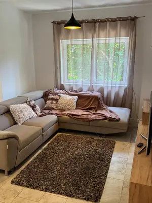 a couch in a living room with a window at Garden House in Budva