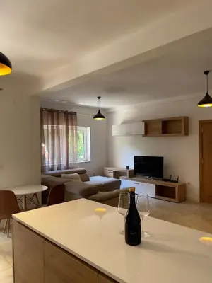 a living room with a bottle of wine on a counter at Garden House in Budva