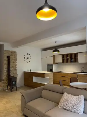 a living room with a couch and a kitchen at Garden House in Budva