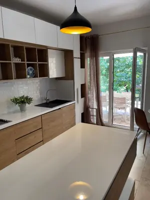 a kitchen with a white counter top in a room at Garden House in Budva