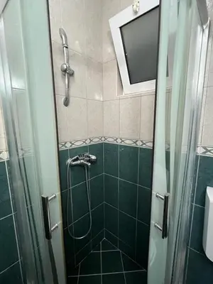 a bathroom with a shower with a glass door at Villa Pelinku in Ulcinj