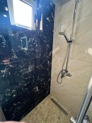 a shower in a bathroom with a glass wall at Villa Pelinku in Ulcinj