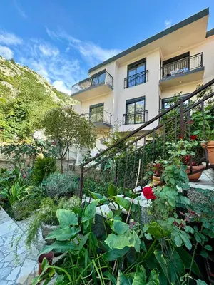 a garden in front of a building with plants at Harmony Garden Apartments in Kotor