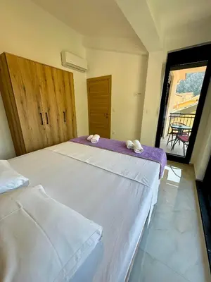 a bedroom with two beds with towels on them at Harmony Garden Apartments in Kotor