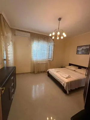 a bedroom with a bed and a window at Villa Noble in Dobra Voda