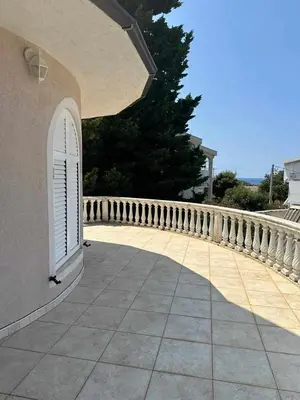a balcony with a white door and a fence at Villa Noble in Dobra Voda