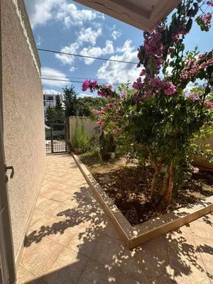 a plant with purple flowers next to a house at Villa Noble in Dobra Voda