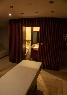 a bathroom with a white counter and a sink at Sleep & Spa 1 in Podgorica