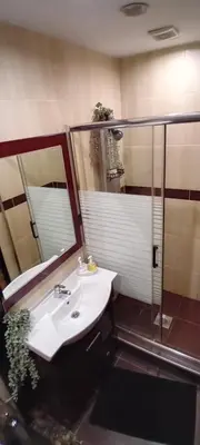 a bathroom with a sink and a shower at Sleep & Spa 1 in Podgorica