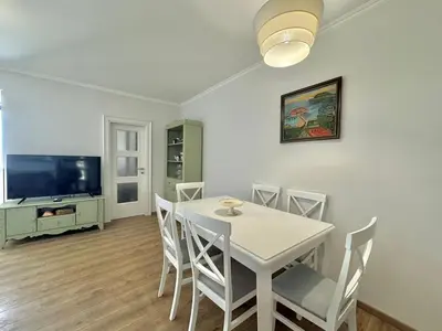 a dining room with a table and chairs and a tv at Lenny One bedroom Apartment Sveti Stefan in Budva