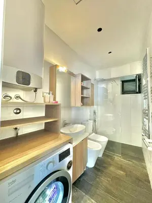 a bathroom with a washing machine and a toilet at Lenny One bedroom Apartment Sveti Stefan in Budva