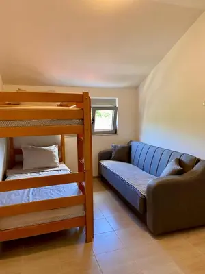 a room with two bunk beds and a couch at Apartment Victor in Kotor