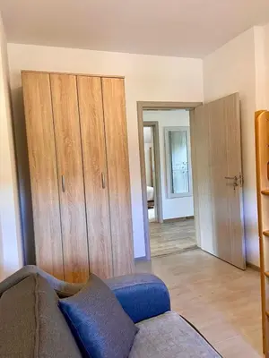 a living room with a couch and wooden cabinets at Apartment Victor in Kotor