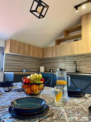 a kitchen with a table with a bowl of fruit on it at Apartment Victor in Kotor