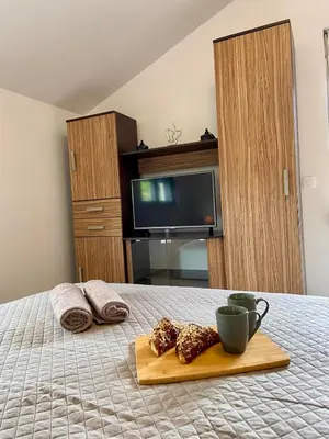 a room with a bed with a tray of food at Apartment Victor in Kotor