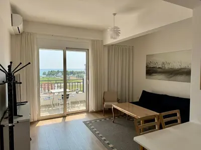 a living room with a couch and a table at Deluxe Apartment with Balcony and Sea View in Bar