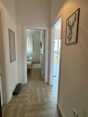a hallway with a hallway leading to a living room at Deluxe Apartment with Balcony and Sea View in Bar